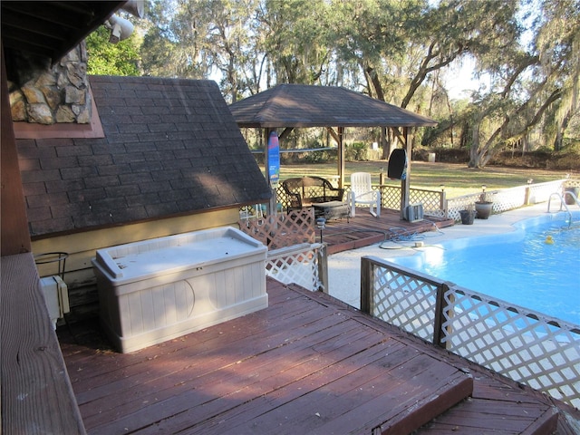 view of swimming pool with a gazebo, a jacuzzi, and a deck