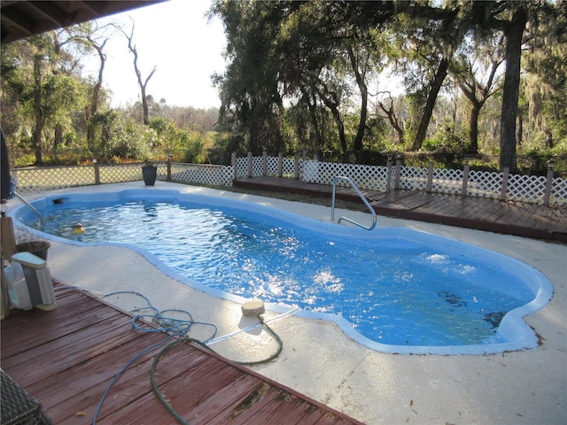 view of swimming pool featuring a wooden deck