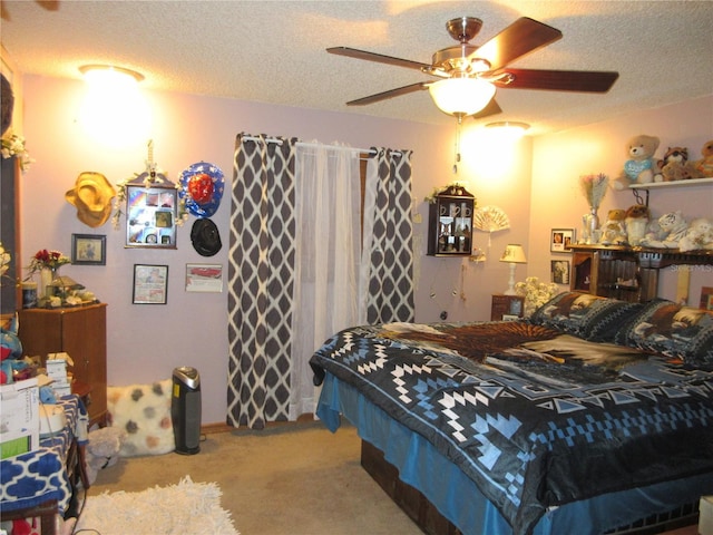 bedroom with ceiling fan, light carpet, and a textured ceiling