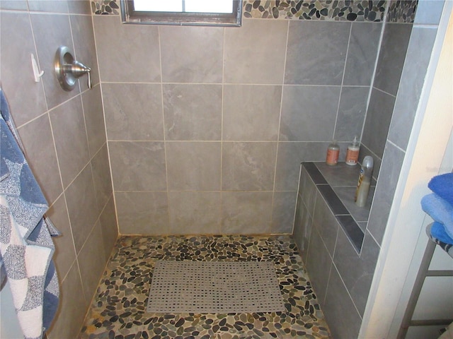 bathroom with tiled shower