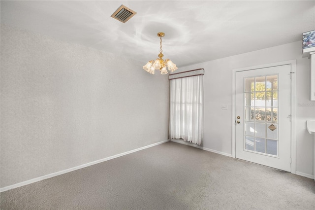 empty room with carpet and an inviting chandelier