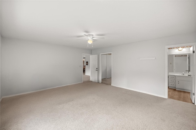 interior space featuring ceiling fan and sink