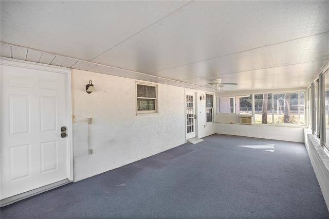 unfurnished sunroom featuring cooling unit and ceiling fan