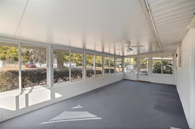 unfurnished sunroom with ceiling fan