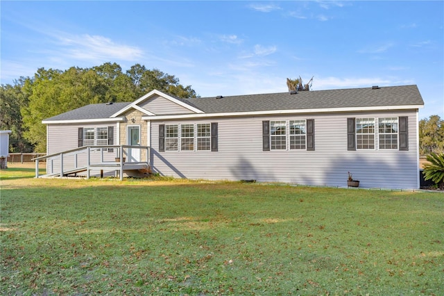 single story home featuring a deck and a front lawn