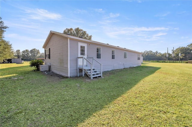 back of property featuring a yard