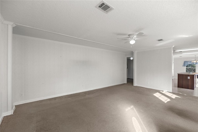 spare room with ceiling fan, carpet, and a textured ceiling