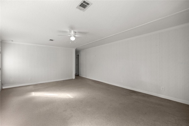 spare room featuring a textured ceiling, ceiling fan, and carpet