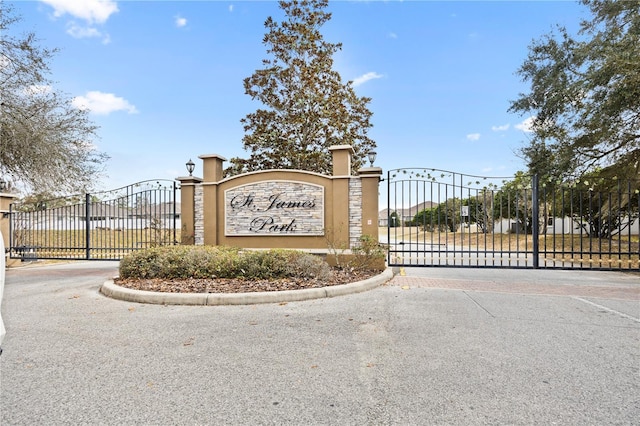 community sign featuring a gate