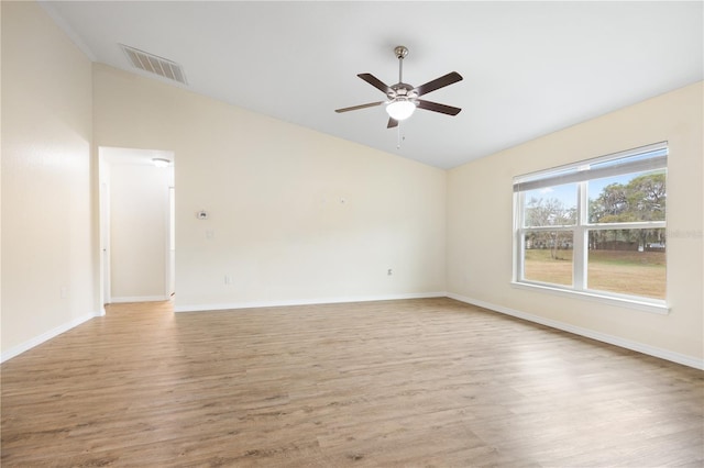 unfurnished room with visible vents, light wood-style floors, ceiling fan, and vaulted ceiling