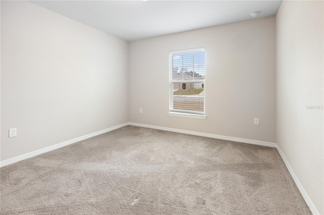 unfurnished room with baseboards and carpet floors