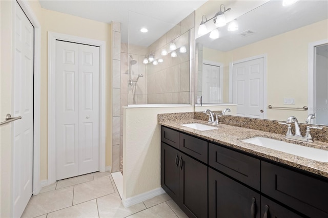 bathroom featuring a sink, a closet, visible vents, and tile patterned floors