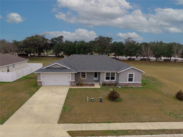 single story home with a front yard, fence, an attached garage, concrete driveway, and stone siding