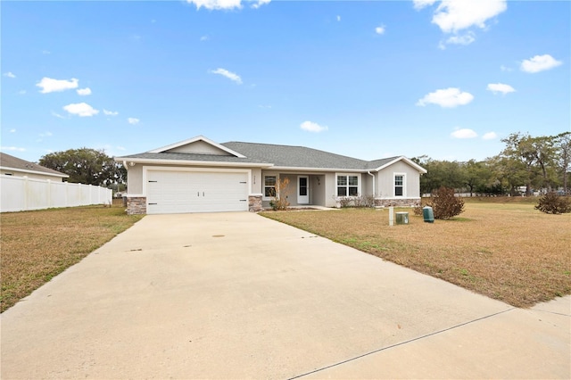 ranch-style home featuring a front lawn, an attached garage, fence, and concrete driveway