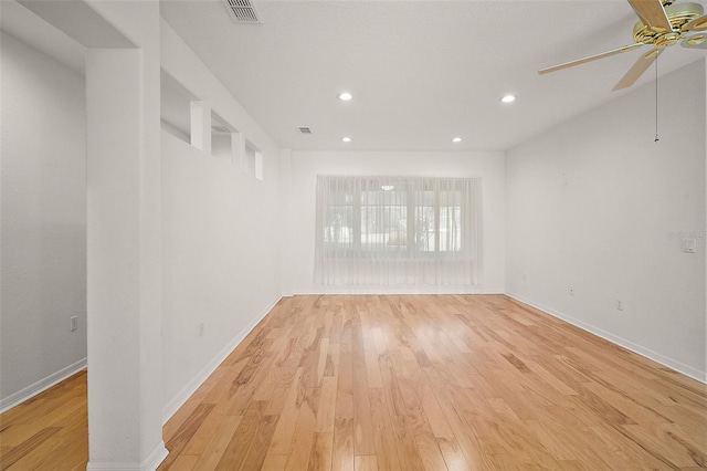 spare room featuring light hardwood / wood-style floors and ceiling fan