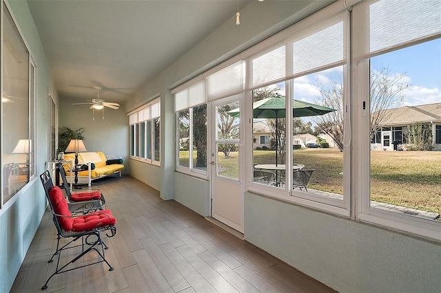 sunroom featuring ceiling fan