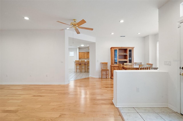 kitchen featuring ceiling fan and light hardwood / wood-style flooring