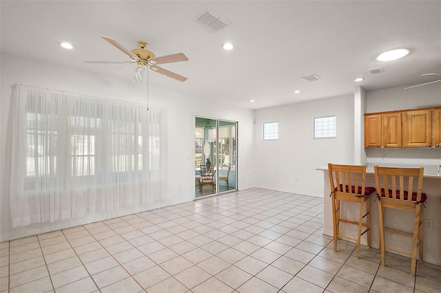 tiled dining area featuring ceiling fan