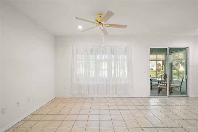 tiled spare room with ceiling fan