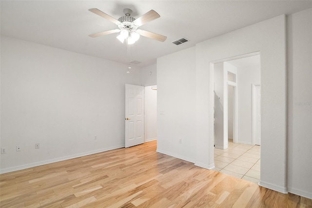 empty room featuring ceiling fan and light wood-type flooring