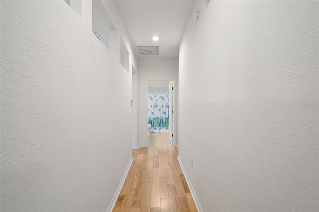 hall with light hardwood / wood-style floors