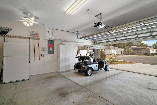 garage with a garage door opener, electric panel, and white fridge