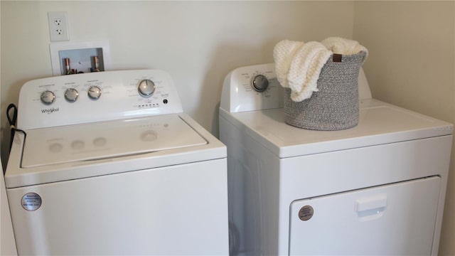 clothes washing area with washer and dryer