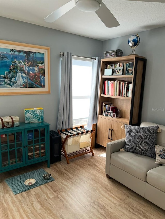 sitting room featuring ceiling fan