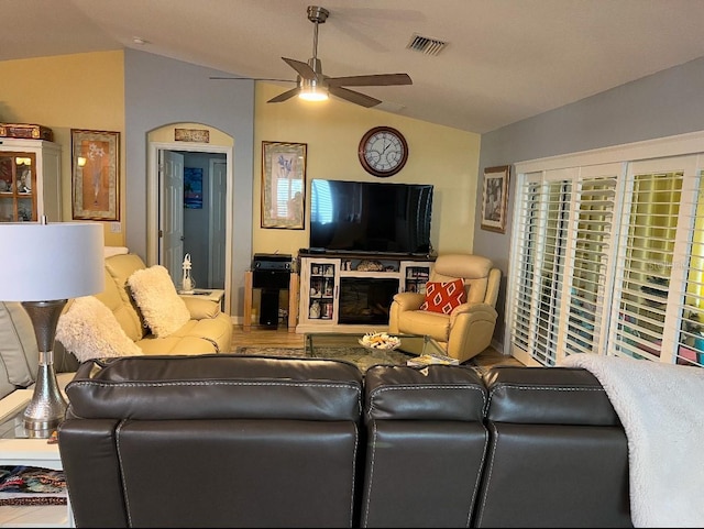 living room with ceiling fan and vaulted ceiling