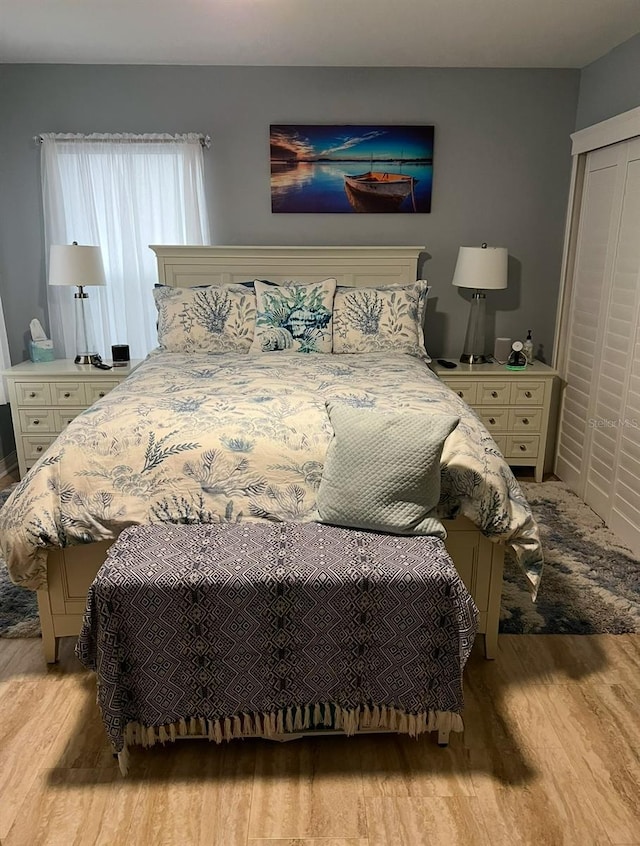 bedroom featuring light hardwood / wood-style flooring and a closet