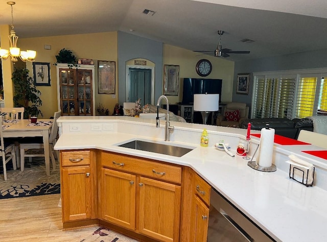 kitchen featuring open floor plan, light countertops, vaulted ceiling, and a sink