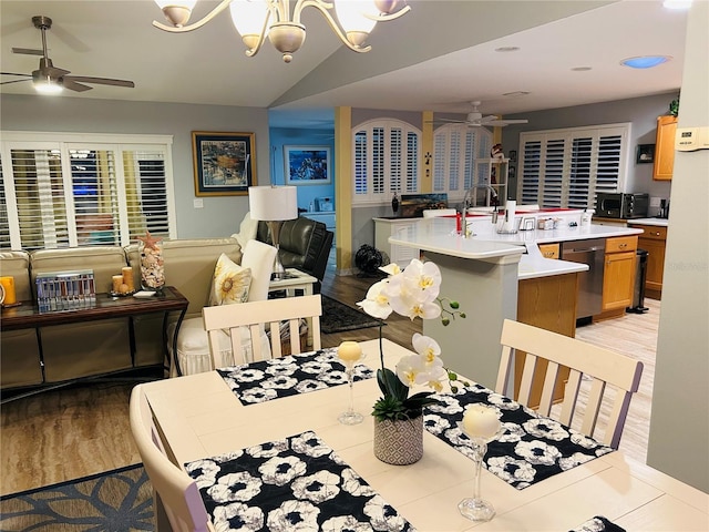 dining room with ceiling fan, a toaster, lofted ceiling, and light wood-style floors