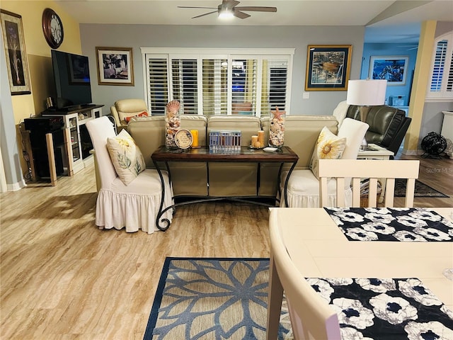 living room with a ceiling fan and wood finished floors