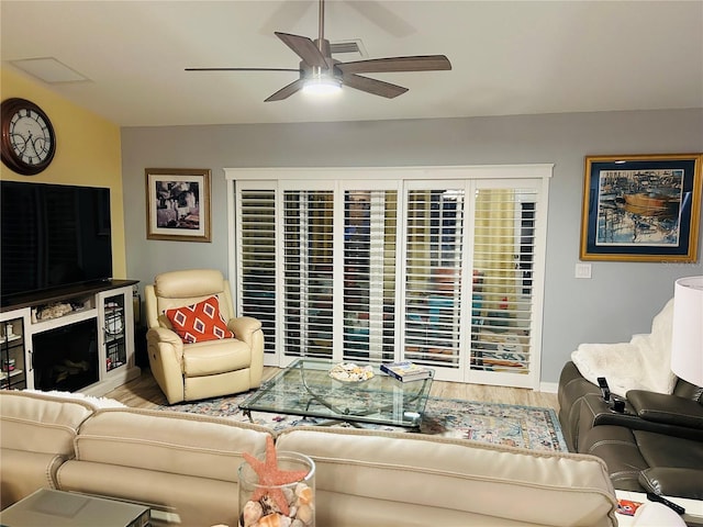 living area featuring wood finished floors and a ceiling fan