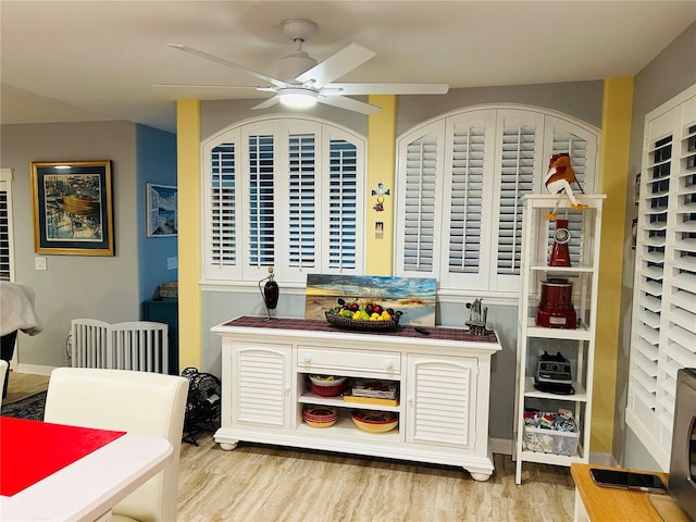 bar featuring ceiling fan and wood finished floors