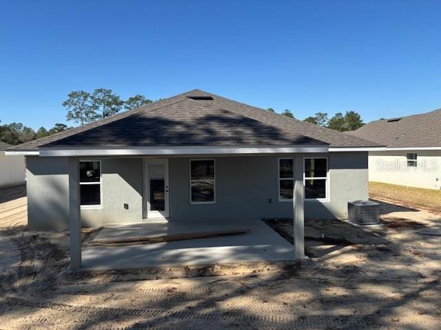 back of house with central AC unit and a patio area