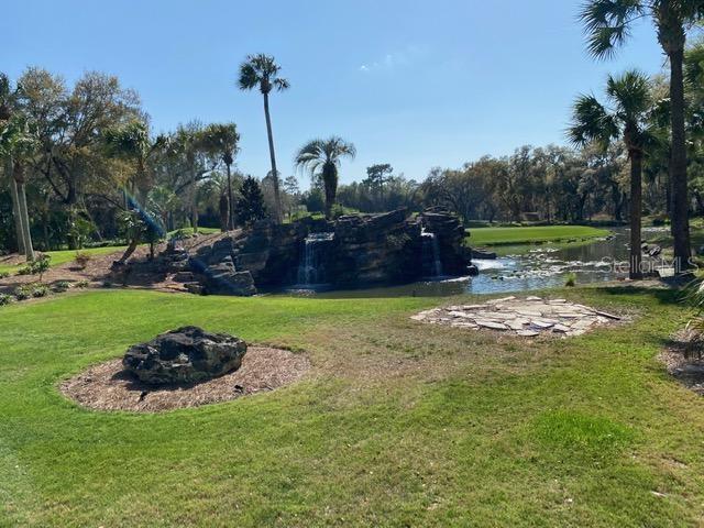 view of yard with a water view and a fire pit