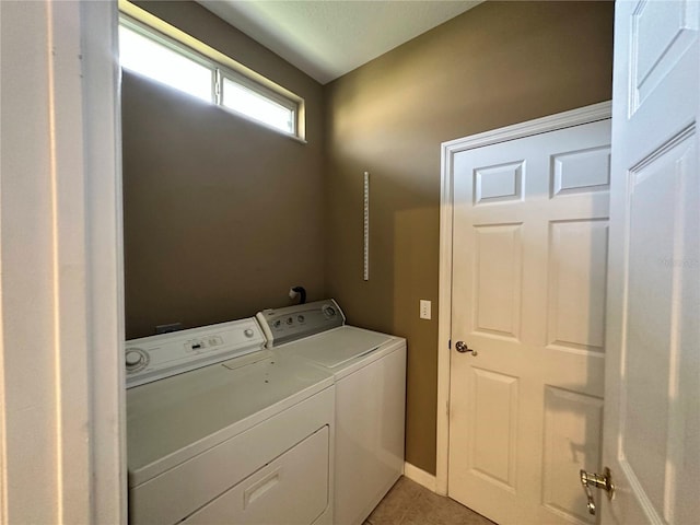 laundry area featuring tile patterned floors and separate washer and dryer