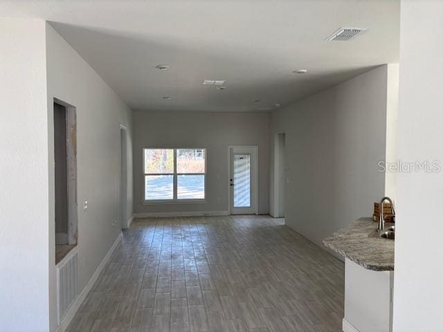 spare room with dark wood-type flooring and sink