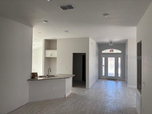 entryway featuring sink and light hardwood / wood-style flooring