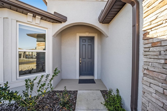 entrance to property with stucco siding