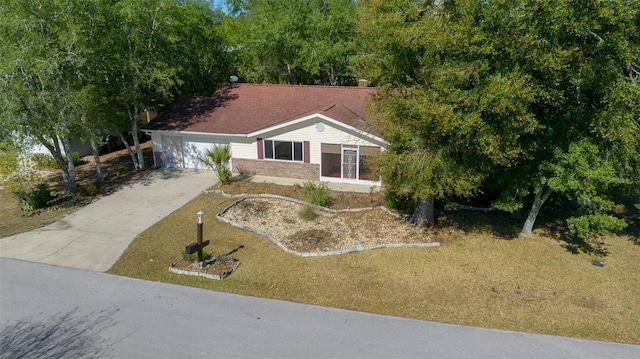 view of front facade with brick siding, an attached garage, and driveway