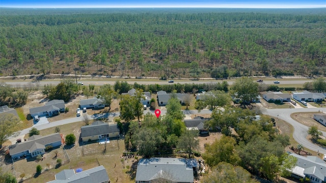 bird's eye view featuring a residential view and a wooded view