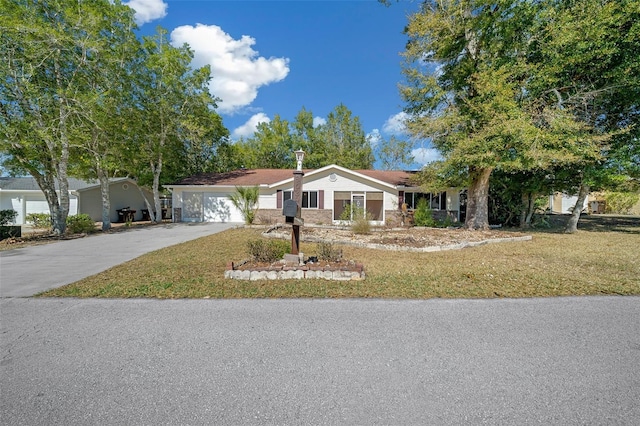 view of front of property with concrete driveway, a garage, and a front yard