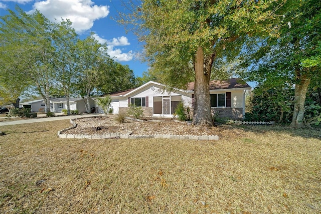 ranch-style home with driveway, a front yard, and a garage