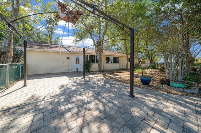 view of front of home with a patio and fence