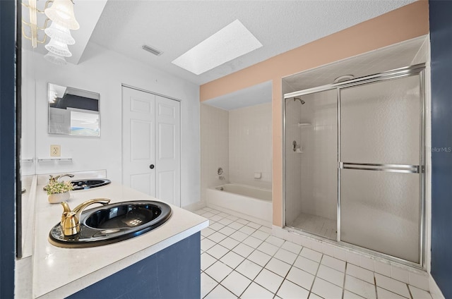 bathroom featuring tile patterned floors, a stall shower, visible vents, and a sink