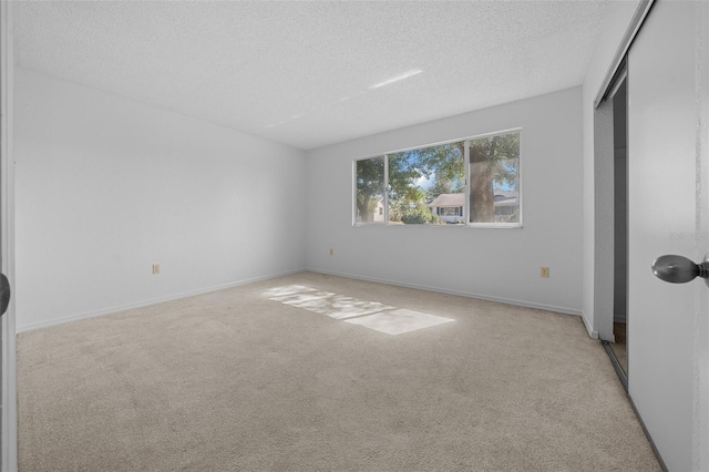 unfurnished bedroom featuring a closet, baseboards, a textured ceiling, and carpet flooring