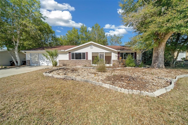 ranch-style house featuring brick siding, driveway, a front lawn, and a garage