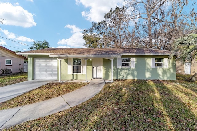 ranch-style home featuring a garage and a front lawn